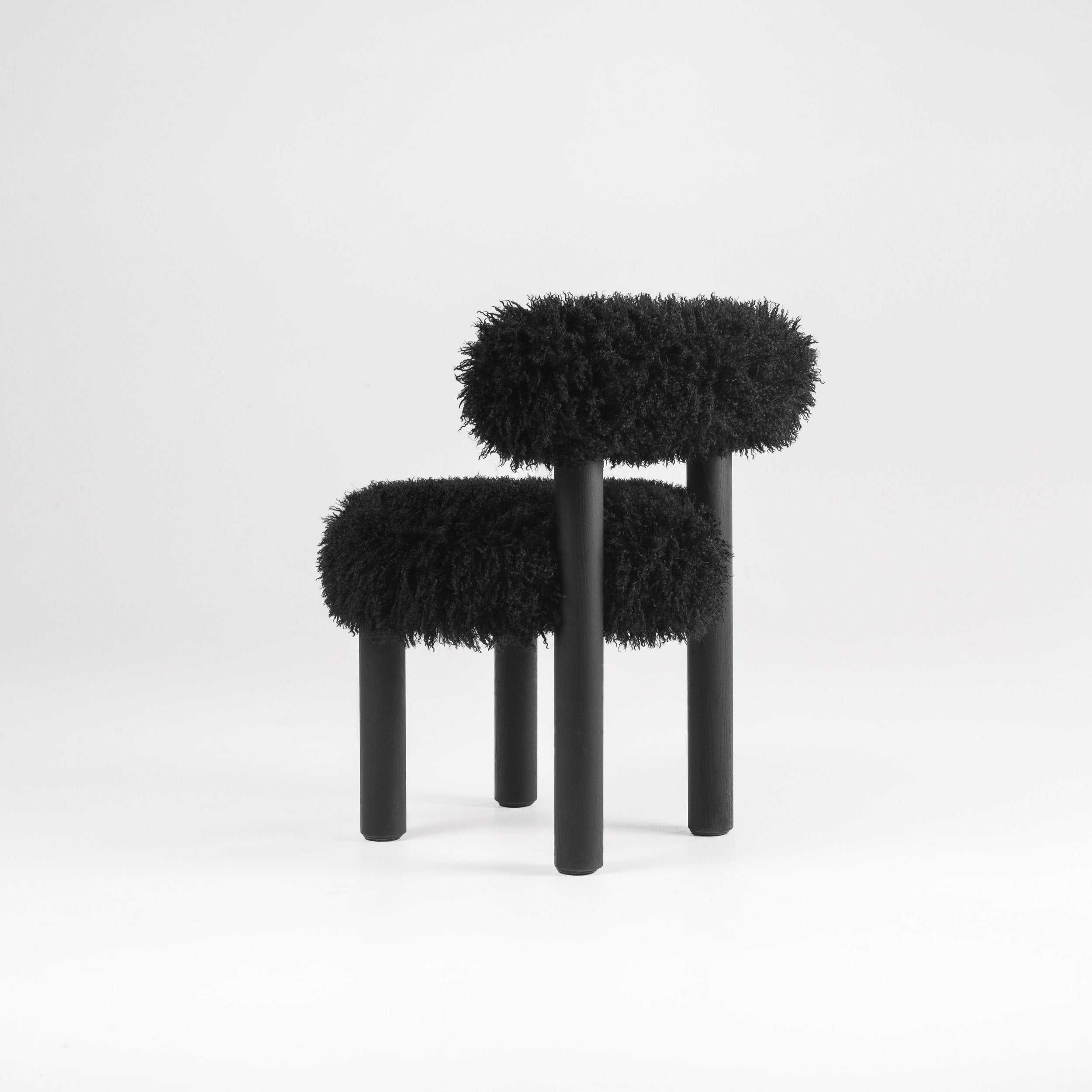 A black chair with legs made of black ashwood